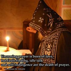 a person in a black robe holding a lit candle next to a cake with the words, uncasing prayer is born of love, but self - finding, idle talk and self - indjuicing are the death of