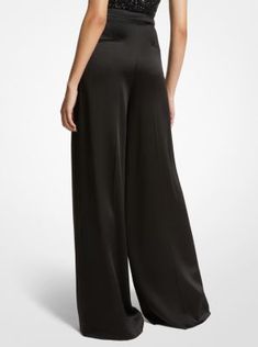 A masterclass in everyday sophistication, these palazzo pants are finely tailored in Italy from liquid-like satin and dyed in a versatile noir hue. The mid-rise silhouette features finely pressed creases that lend effortless movement with each step. Further accentuate the dramatic wide-leg cut with soaring high-heel sandals. Satin Palazzo Pants, Michael Kors Collection, Festival Dress, Palazzo Pants, Heel Sandals, High Heel Sandals, Master Class, High Heel, Mid Rise