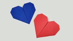 two origami hearts sitting next to each other