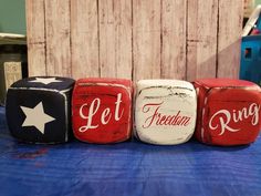 three red, white and blue painted blocks with the words let america ring on them
