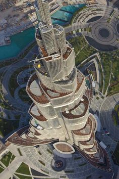 an aerial view of the burj tower in dubai, with other buildings around it