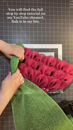 a person is using a cloth to clean watermelon