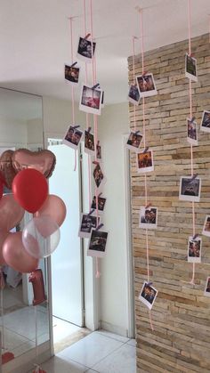 balloons and photos hanging from the ceiling