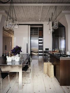 a large open kitchen and dining room with wood flooring