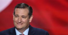 a close up of a person wearing a suit and tie with a flag in the background