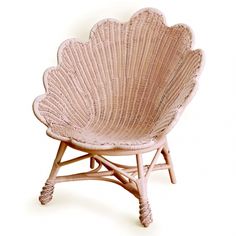 a wicker shell shaped chair on a white background