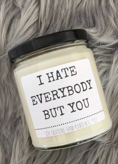 i hate everybody but you soy candle on top of a furry animal fur covered surface