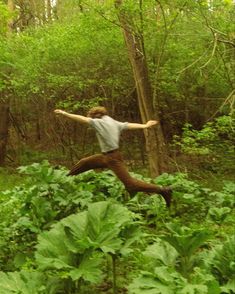 a man is jumping in the air with his arms outstretched