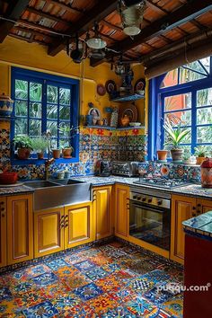 a colorful kitchen with blue windows and yellow cabinets is pictured in this image taken from the inside