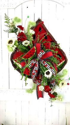 a basket filled with lots of green and red flowers