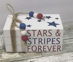 a white box with red, white and blue stars and stripes necklace on top of it