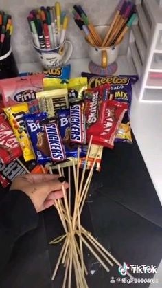 some candy bars sitting on top of a white table with yellow wrappers next to them