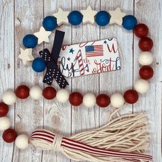 a red, white and blue beaded necklace with an american flag tassel