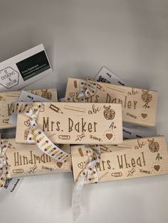 four wooden stamps with the words, mr and mrs baker on them are tied together