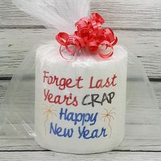 a wrapped gift box with the words forget last year's crap happy new year