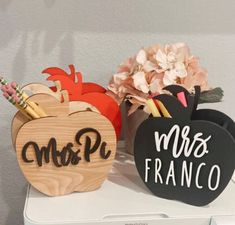 two wooden pumpkins are sitting on top of a washing machine, with the word mr and mrs franco painted on them