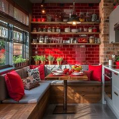 a kitchen with red brick walls and wooden shelves