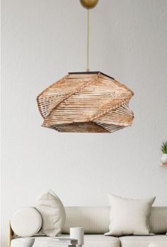 a living room filled with furniture and a light fixture hanging from the ceiling above it