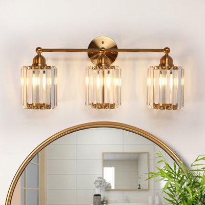 Transform your sophisticated bathroom, living room, or bedroom into a haven of sheer elegance with our opulent 3-light dimmable bathroom vanity light. The captivating electroplated brass finishes seamlessly merge with the crystal-adorned glass shade, introducing a touch of modern luxury and extravagant allure to your intimate spaces. Regardless of your decor style, this vanity light stands out as a unique decorative element, adding a touch of extravagant charm to your home. Elevate your home's a Gold Bathroom Vanity, Powder Room Lighting, Gold Light Fixture, Bathroom Vanity Lights, Gold Bathroom Decor, Sophisticated Bathroom, Gold Fixtures, Vanity Light Fixtures, Bathroom Vanity Light