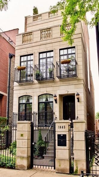 an apartment building with wrought iron fence and gate