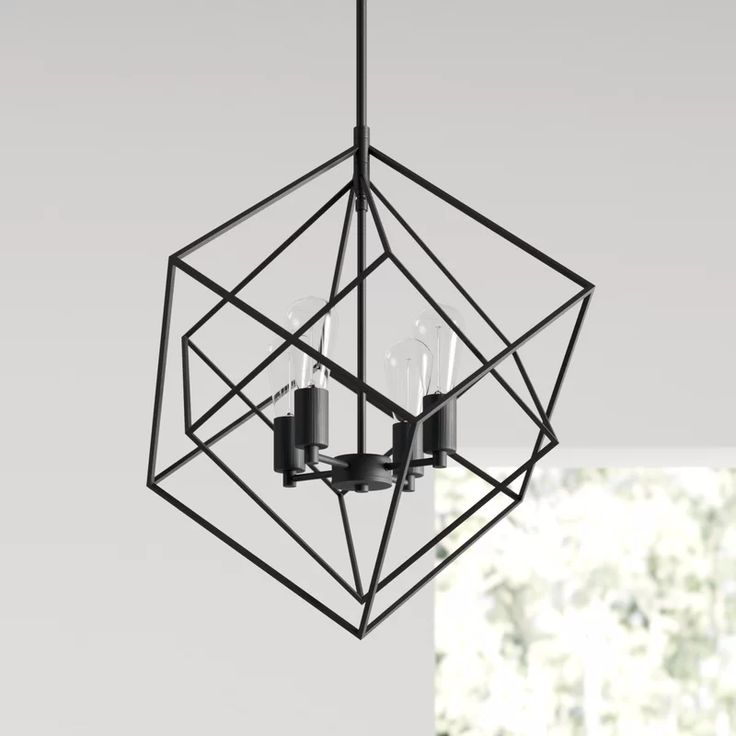 a black chandelier hanging from the ceiling in a room with white walls and windows