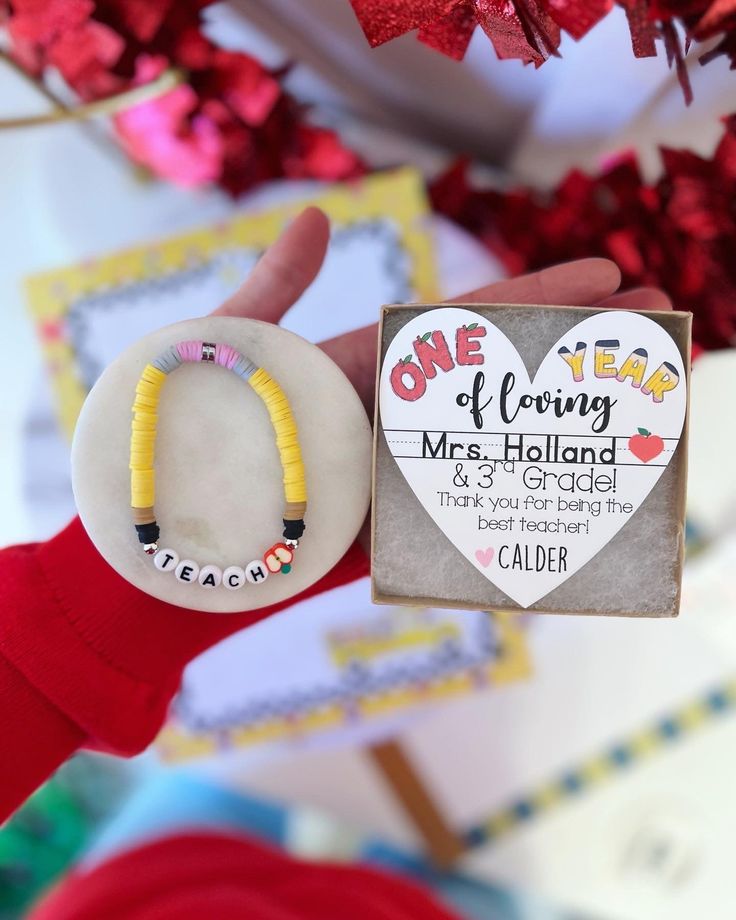 someone is holding up a magnet with the words one year of loving mrs holland on it