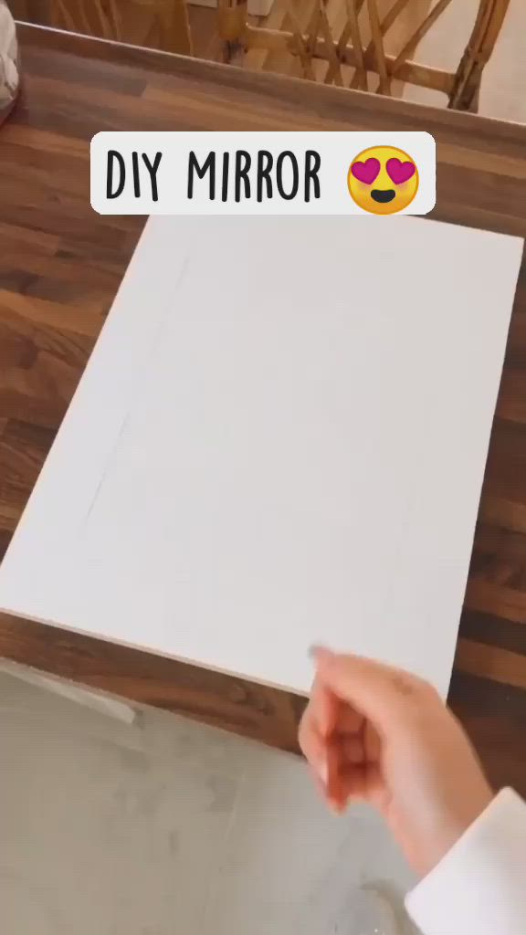 This may contain: a person pointing at a white piece of paper with the words diy mirror on it