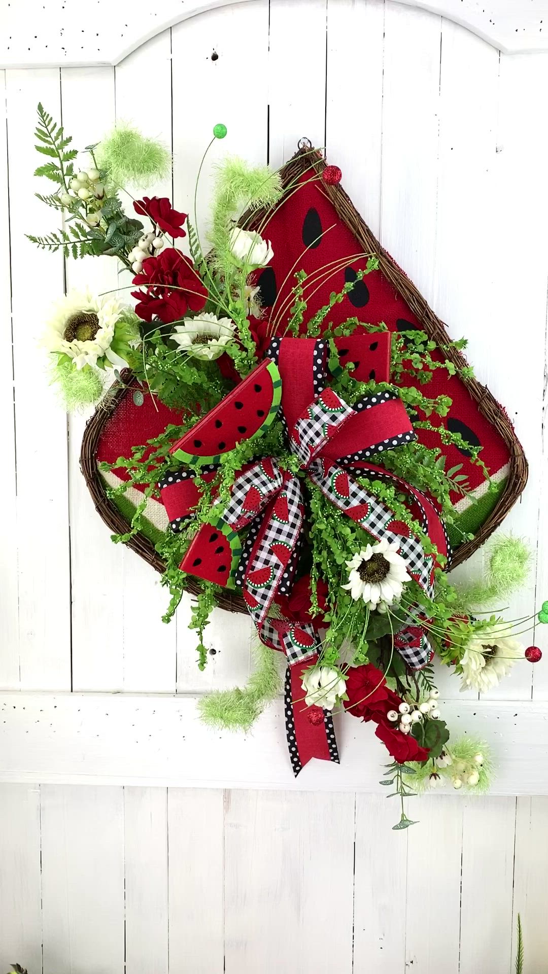 This may contain: a basket filled with lots of green and red flowers