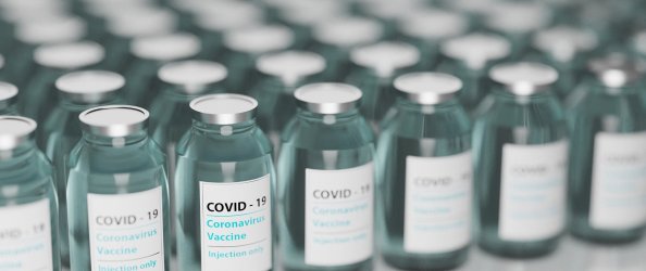 Rows of small vials which read: 'COVID-19, Coronavirus vaccine'.