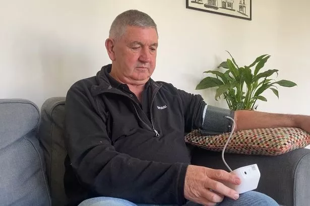 Peter Jackson checking his blood pressure at his Saintfield home