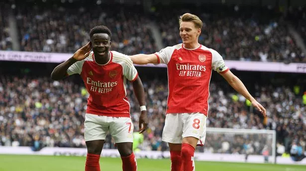 Bukayo Saka celebrates the 1st Arsenal goal with (R) Martin Odegaard during the Premier League match between Tottenham Hotspur and Arsenal FC