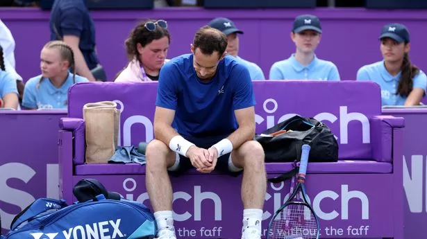 Andy Murray sits down after retiring injured from a match against Jordan Thompson at the cinch Championships