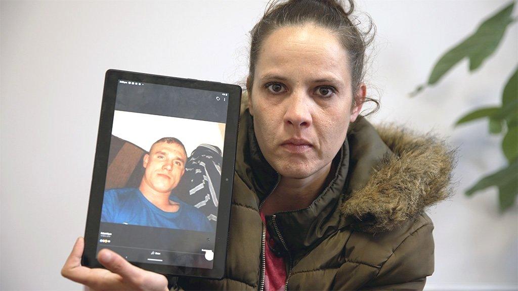 Joanne holding a photo of Robert