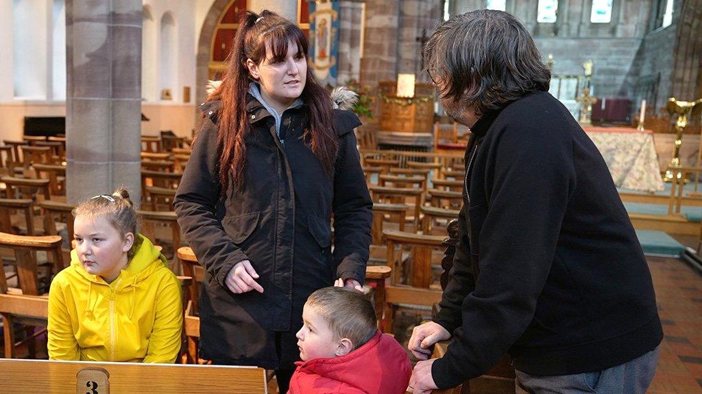 Father Alex talking to Demi Lea