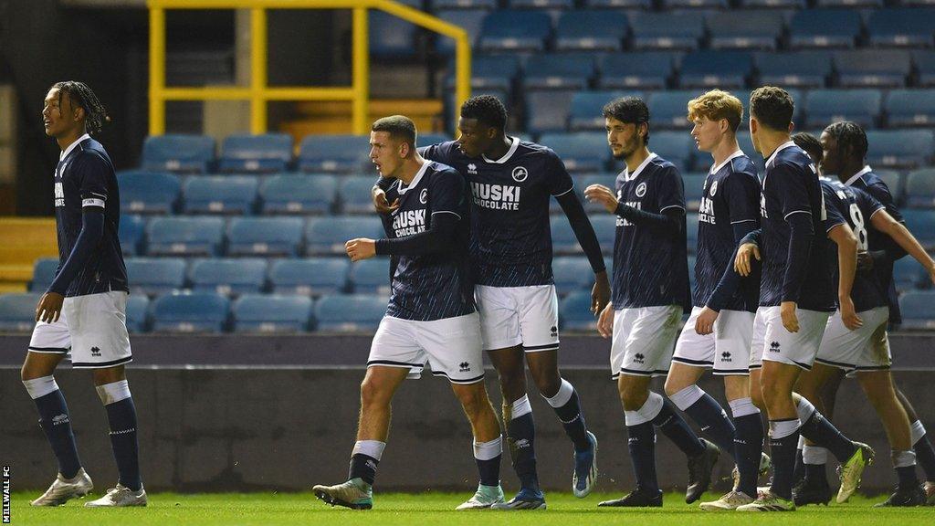 Millwall players walk back towards kick off after celebrating a goal