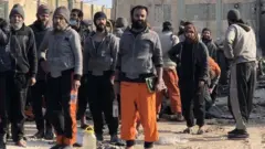 Photograph posted by SDF spokesman Farhad Shami showing suspected IS militants surrendering at Ghwayran prison in Hasaka, Syria (26 January 2022)