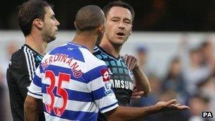 England and Chelsea captain John Terry (right) speaking with QPR's Anton Ferdinand during their teams' Premier League match at Loftus Road