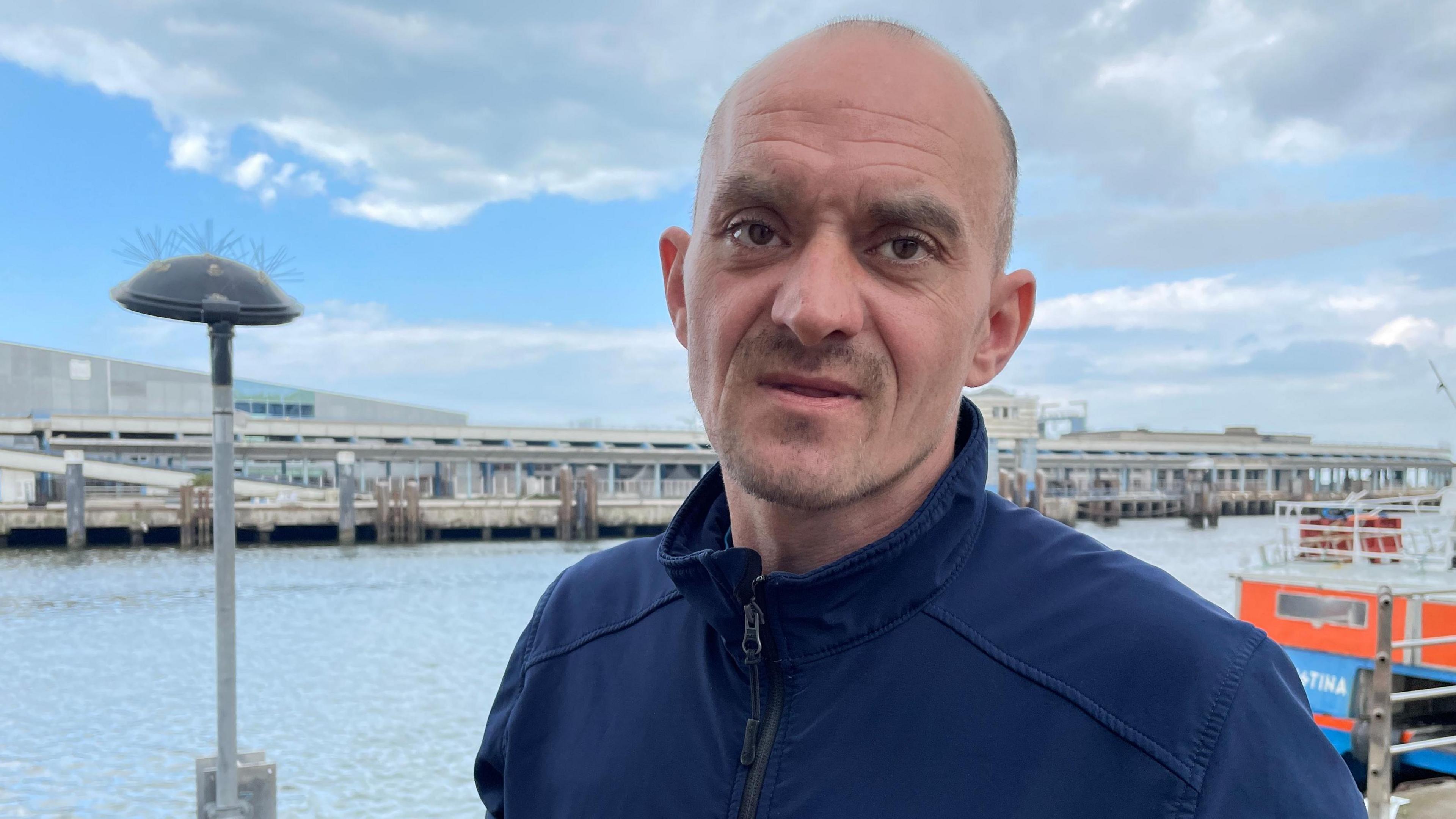 Fisherman Bruno Hecquet looks at the camera from the quayside.