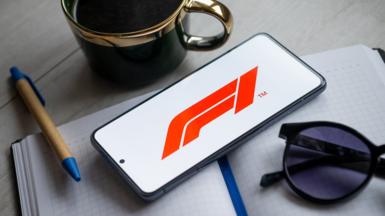 F1 logo on phone and pen and sunglasses