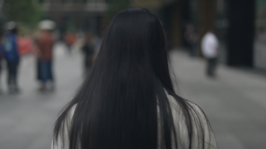 Woman with long hair facing away from the camera