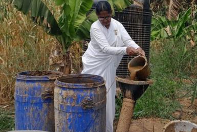 Rukmini Baburao Kumbhar pours slurry into a pipe