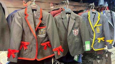 School blazers from a variety of schools hanging up