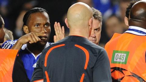 Chelsea striker Didier Drogba points his finger at referee Tom Ovrebo as his team-mates surround officials at the end of their Champions League semi-final exit against Barcelona in 2009