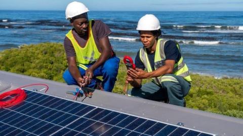 Two engineers with a solar panel