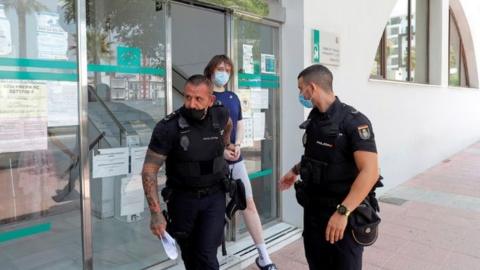 Joseph James O'Connor is lead by Spanish police officers as he leaves a court after being arrested in 2021