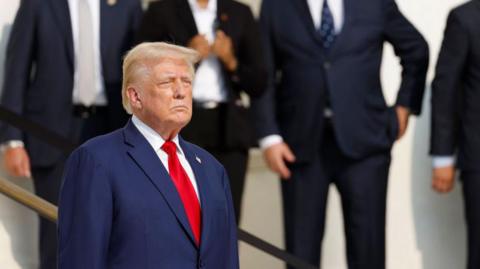  Republican presidential nominee and former US President Donald Trump looks on during a wreath laying ceremony at the Tomb of the Unknown Soldier at Arlington National Cemetery on 26 August 2024 in Arlington, Virginia 