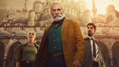 The Turkish Detective promotional image featuring Yasemin Allen, Haluk Bilginer and Ethan Kai. 

They're standing in front of a Turkish style building