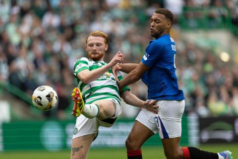 Celtic and Rangers players challenge for the ball