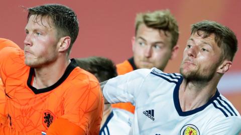 Netherlands forward Wout Weghorst and Scotland defender Liam Cooper