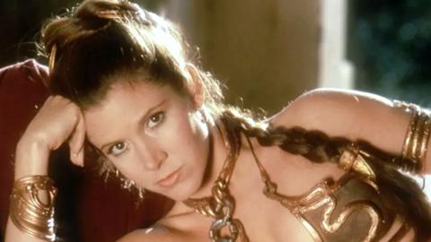 Carrie Fisher playing Princess Leia in Star Wars, wearing gold bikini
